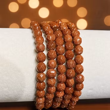 Sandsten "Goldstone" Röd 6mm pärlor (Fasetterad) Armband