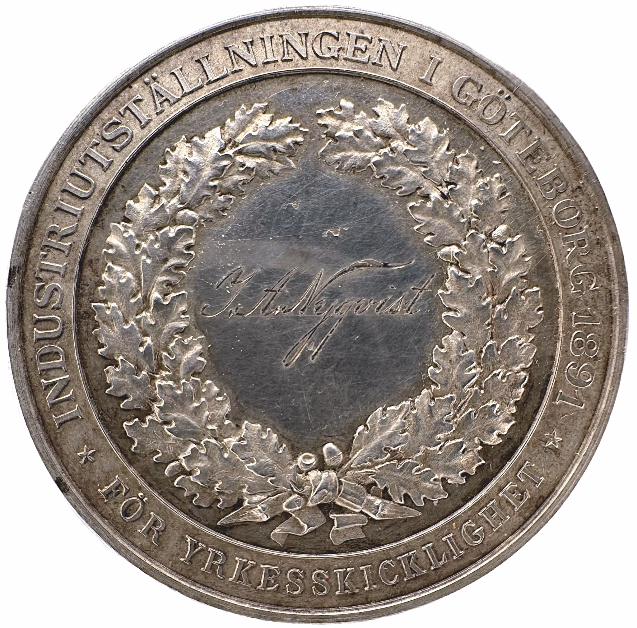Oskar II - Göteborgs hantverks och industriförenings belöningsmedalj utdelad till J.A. Nyqvist 1891 av Adolf Lindberg