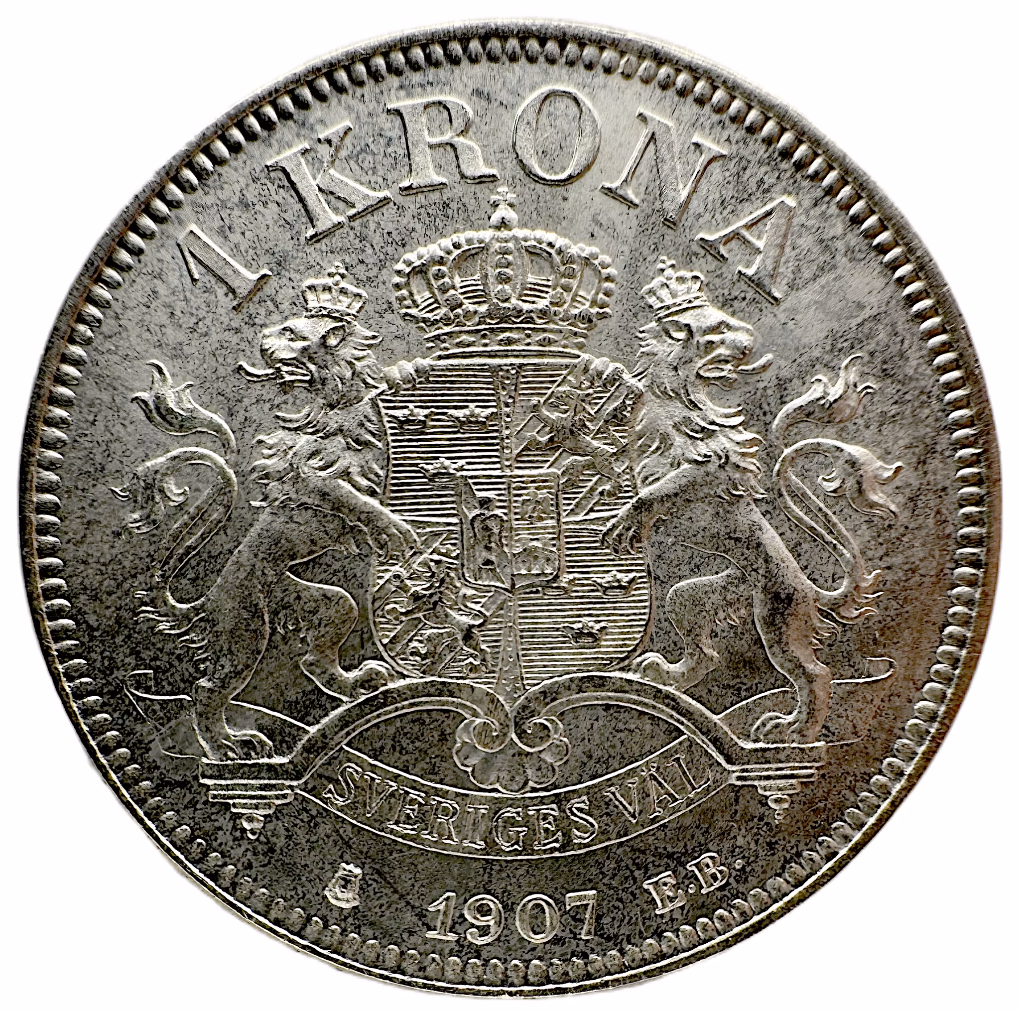 Oskar II, Stockholm, 1 Krona 1907 - Ett vackert ocirkulerat exemplar med full präglingslyster och endast obetydliga hanteringsmärken - En sjöofficer på tronen