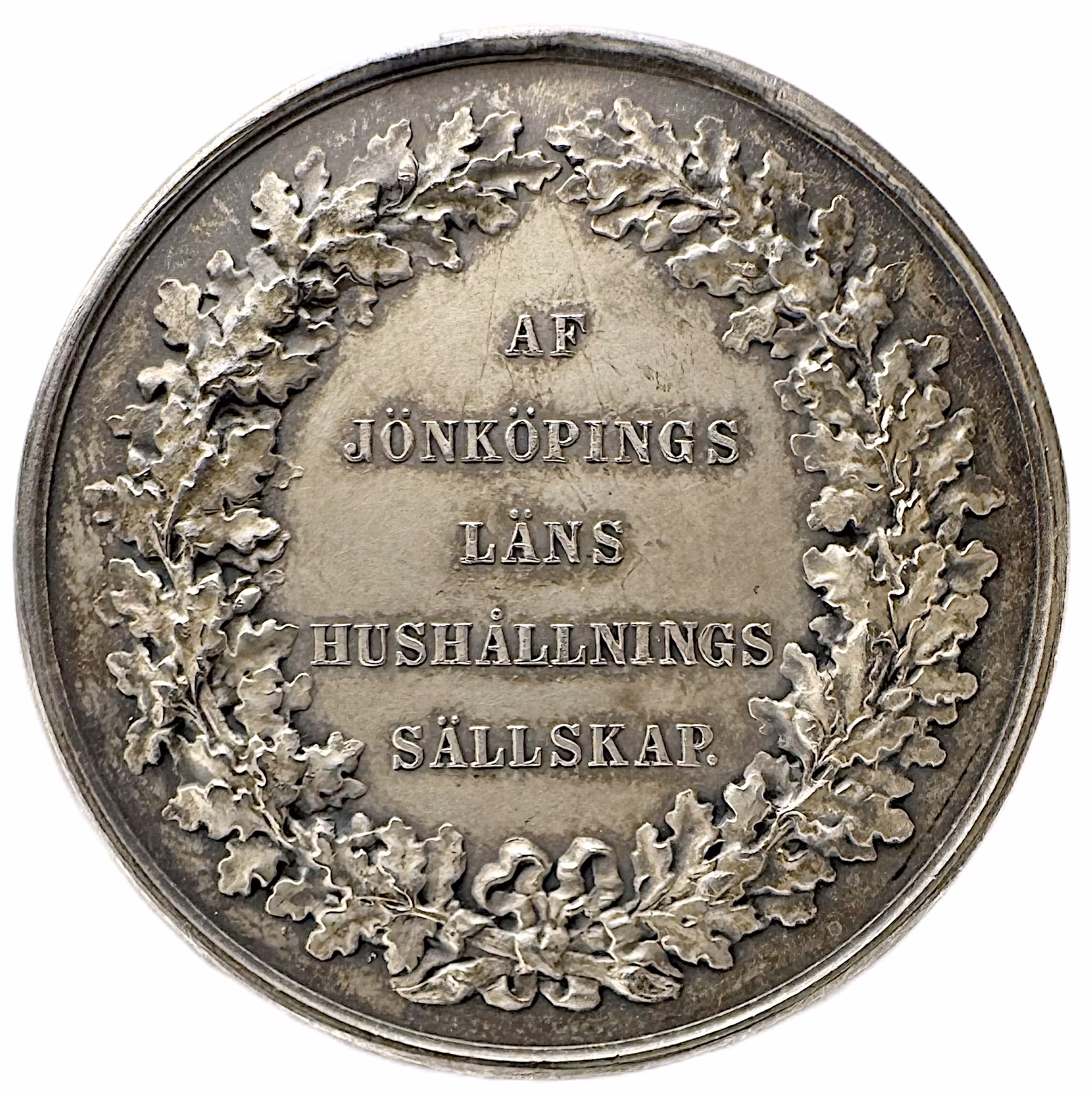 Oskar II: Jönköpings läns kungliga hushållningssällskap (modell 1873) av Lea Ahlborn - En hyllning till den småländska fliten