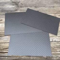 Paneler t mittkonsolen, äkta matt carbon fiber - Tesla Model 3 2023.10-/Y 2025.3-