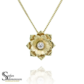 Gold lotus pendant with a diamond