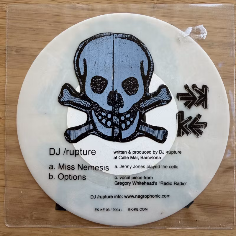 DJ RUPTURE Miss Nemesis (White vinyl) (Ek-ke – Sweden original) (VG+/EX) 7"
