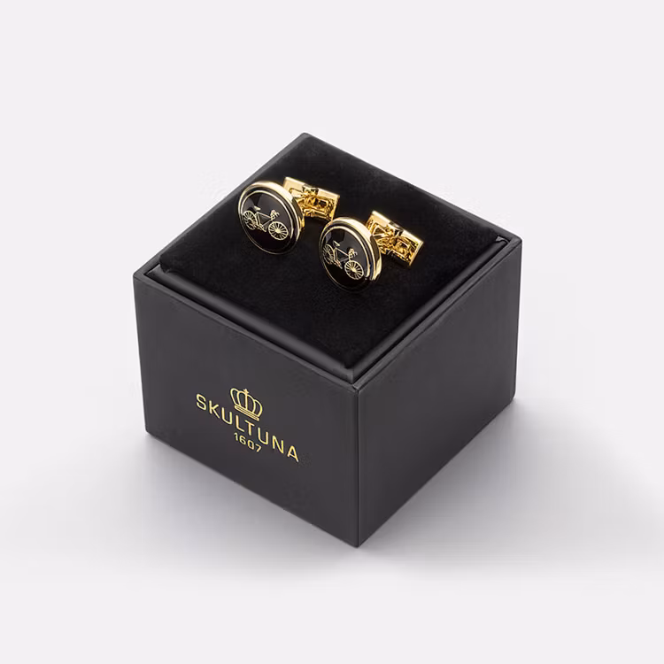 Skultuna Manschettknappar Themocracy Bike Nero, cykelinspirerade manschettknappar i guldpläterad mässing.