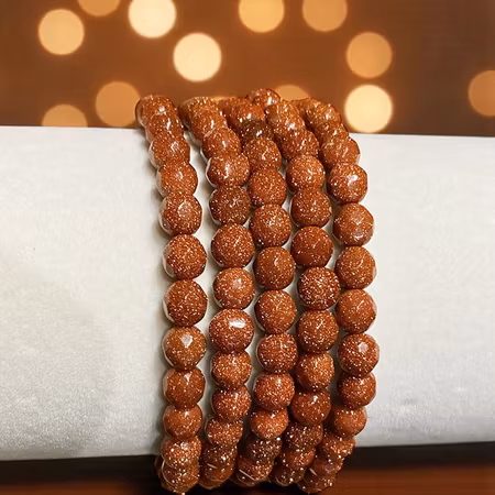 Sandsten "Goldstone" Röd 6mm pärlor (Fasetterad) Armband