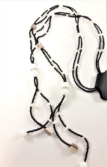Öppet svart halsband med små och stora pärlor och stenar i vitt samt glittrande strass