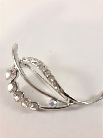 Vacker silverfärgad brosch med glittrande strass