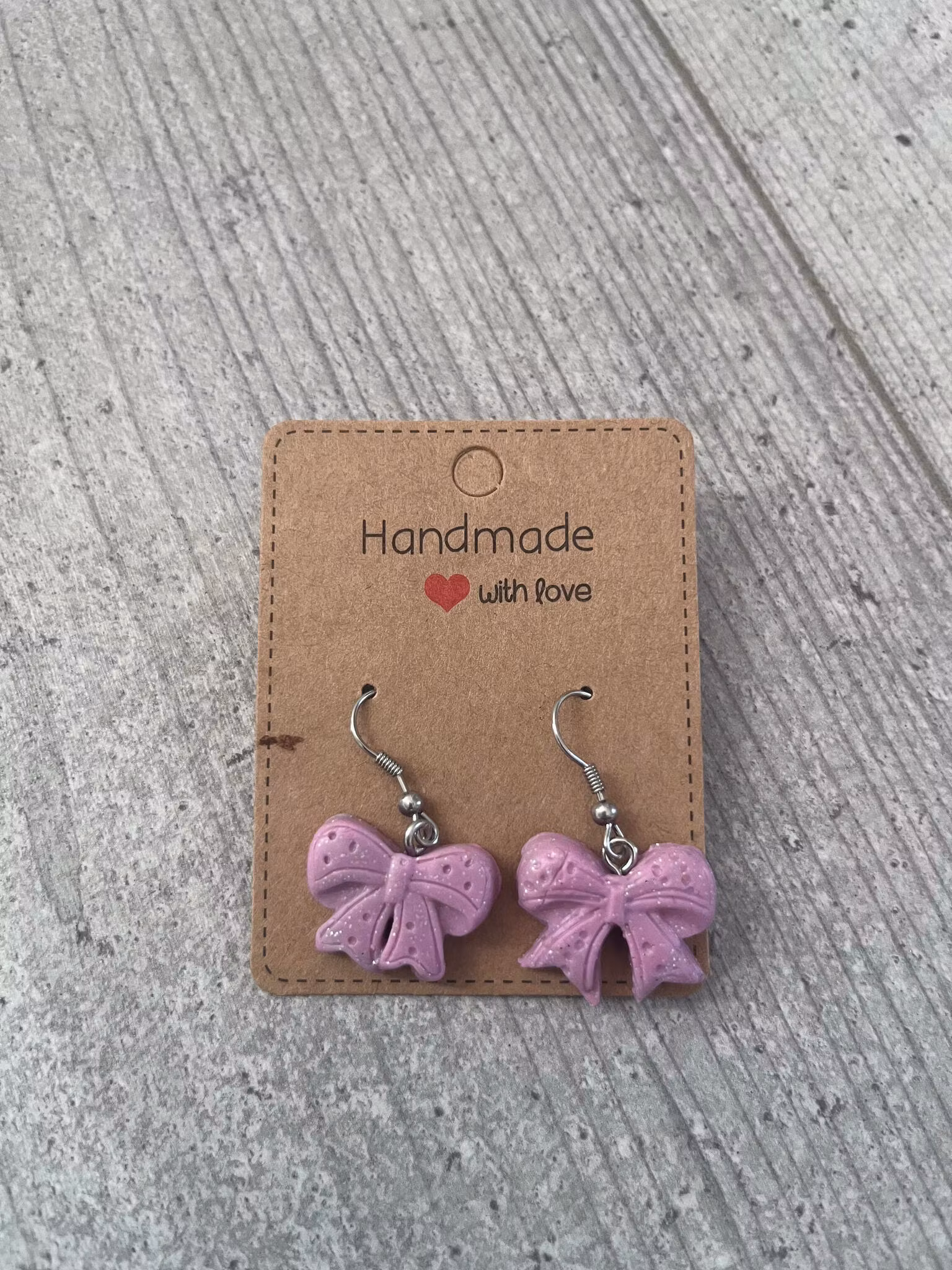 ÖRHÄNGE, ROSETT (ljuslila/glitter)