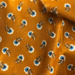 Bomullstyg blommigt lejongult