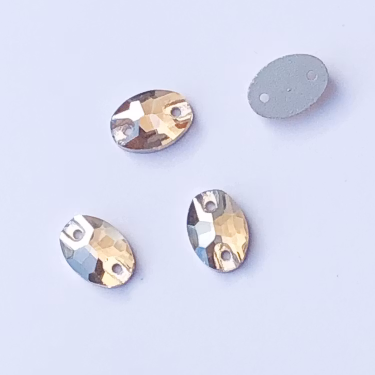 Kristallpärla platt oval 7x10mm guld
