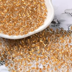 Seedbead 6/0 transparent goldenlined