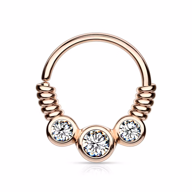 Piercingring snurrad med tre ädelstenar