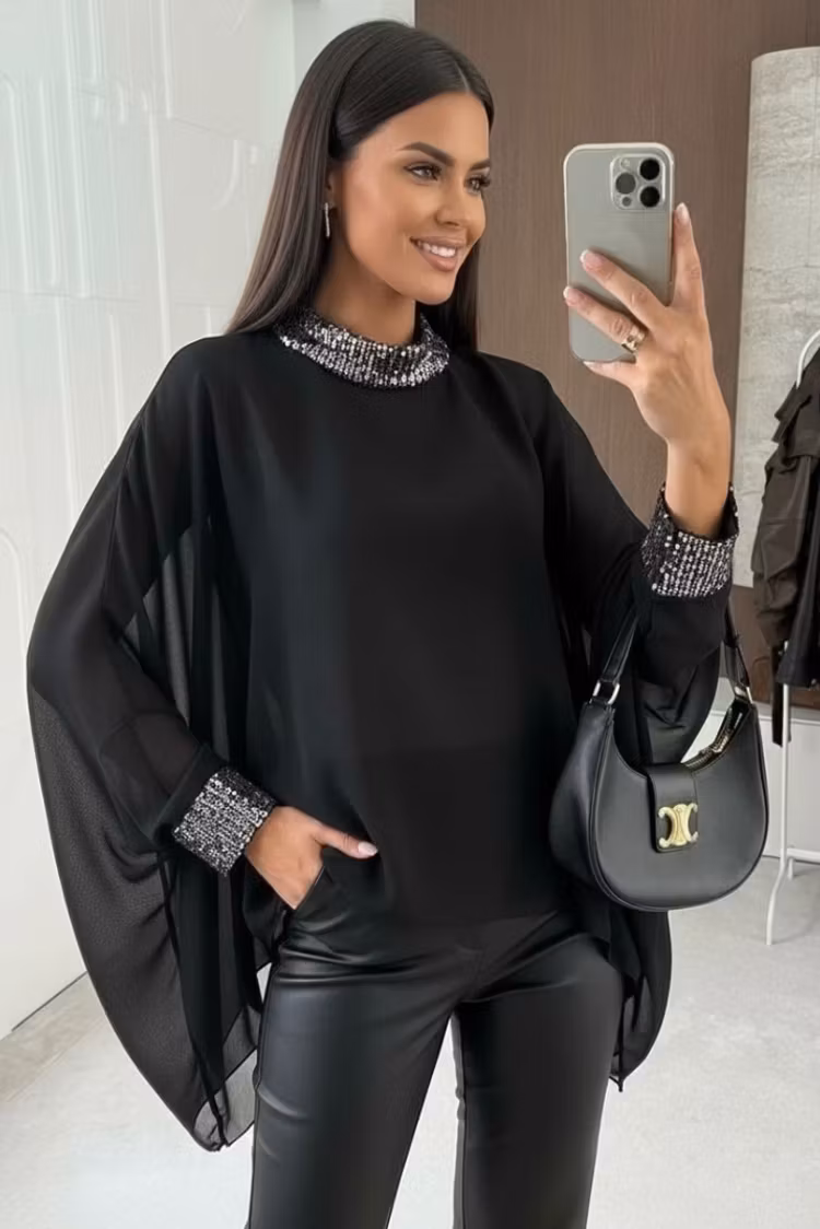 Svart blus vid med paljettdekorationer