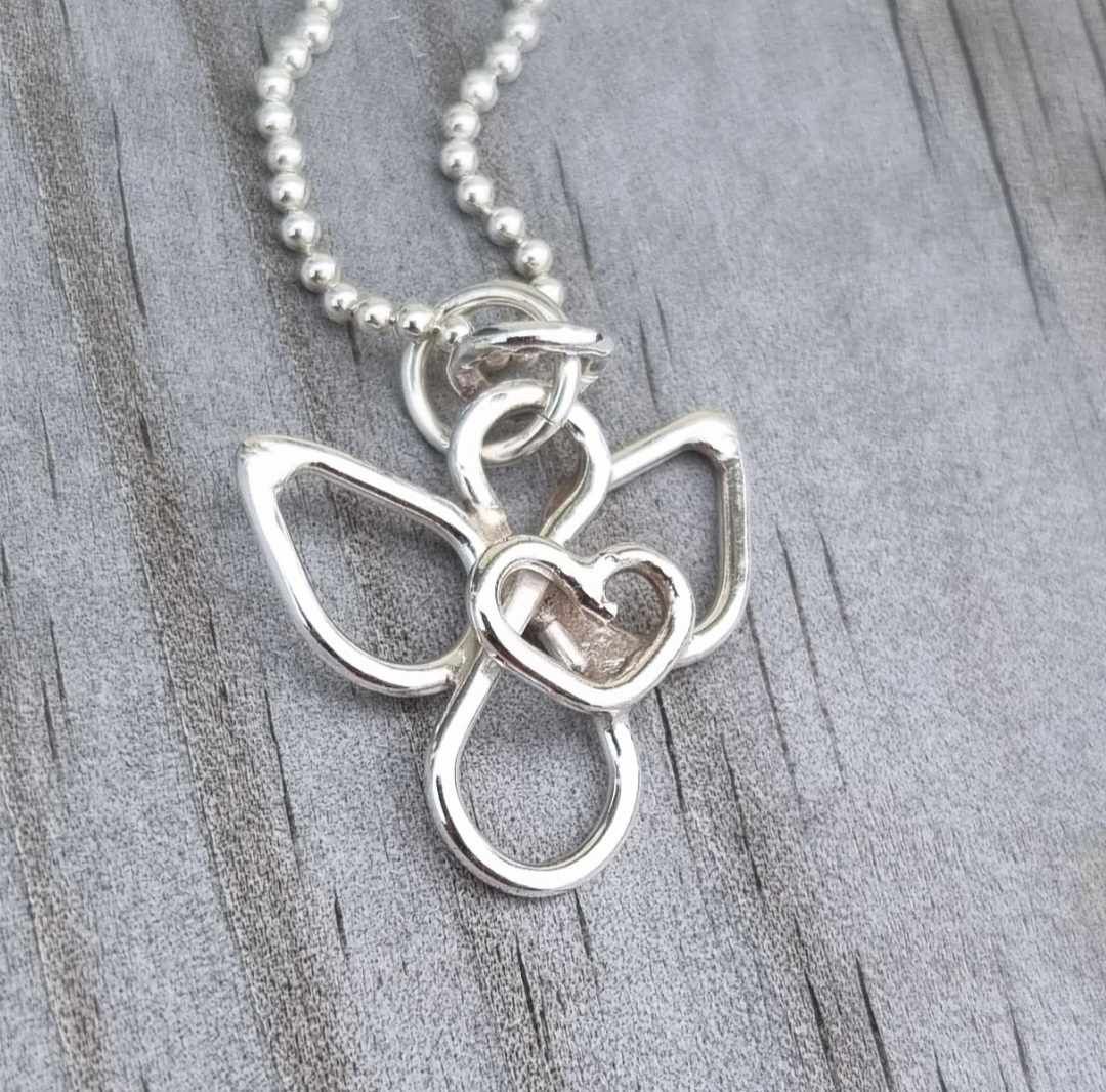 Small handmade silver angel with an eternity sign as a body