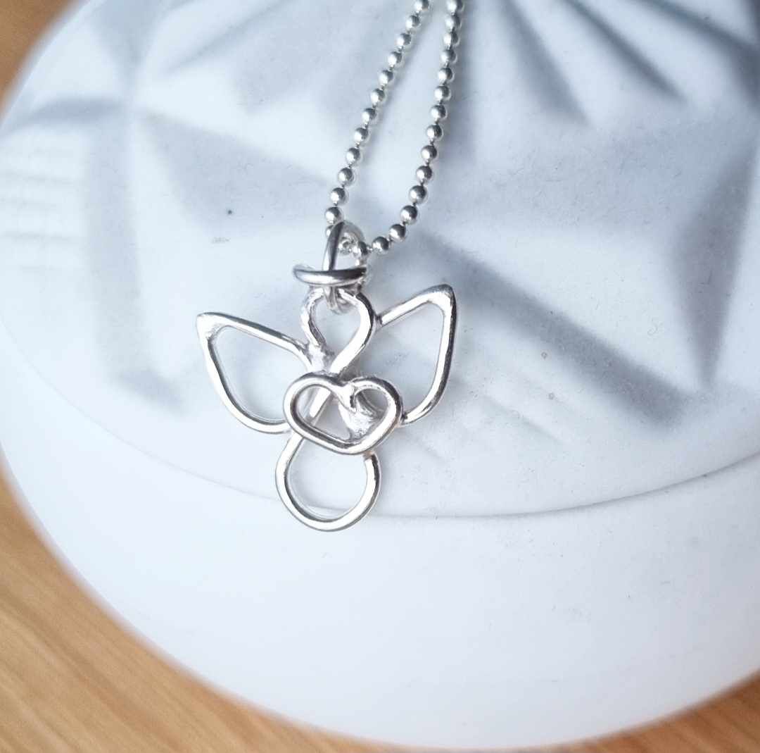 Small handmade silver angel with an eternity sign as a body