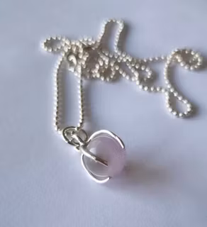 A nice necklace with a light purple/pink stone, round, set in sterling silver