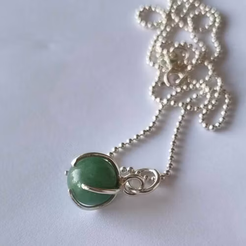 A beautiful necklace with a green round stone, set in sterling silver.