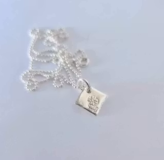 Fyrklöver ett fint halsband med en fyrklöver på silverbricka som en romb