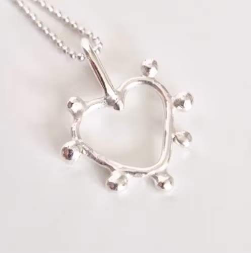 Silverdagg en fin hjärtansberlock med daggdroppar i silver