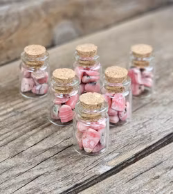 Rodokrosit, små trumlade i glasflaska