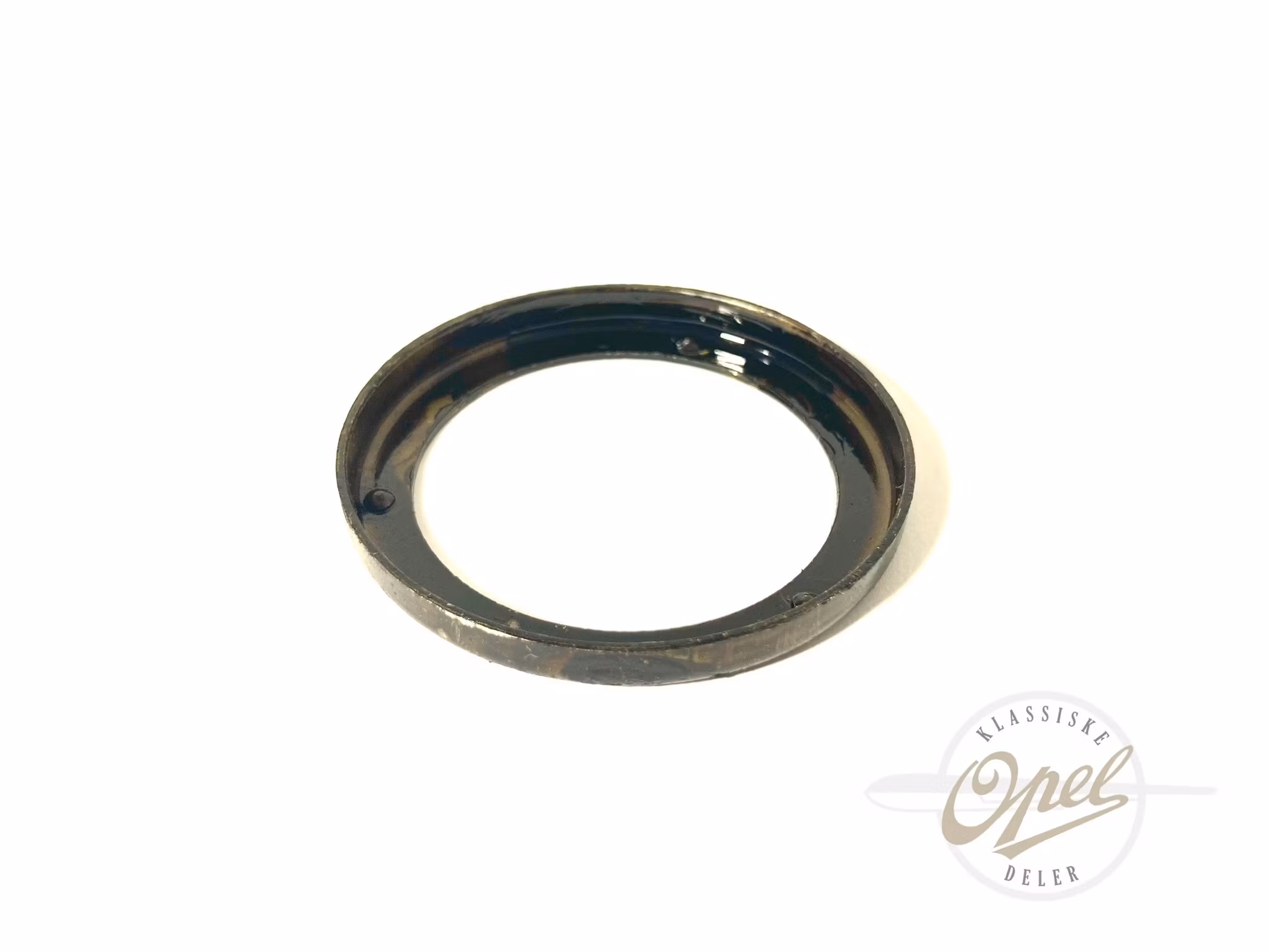 Holder til pakning i registerdeksel