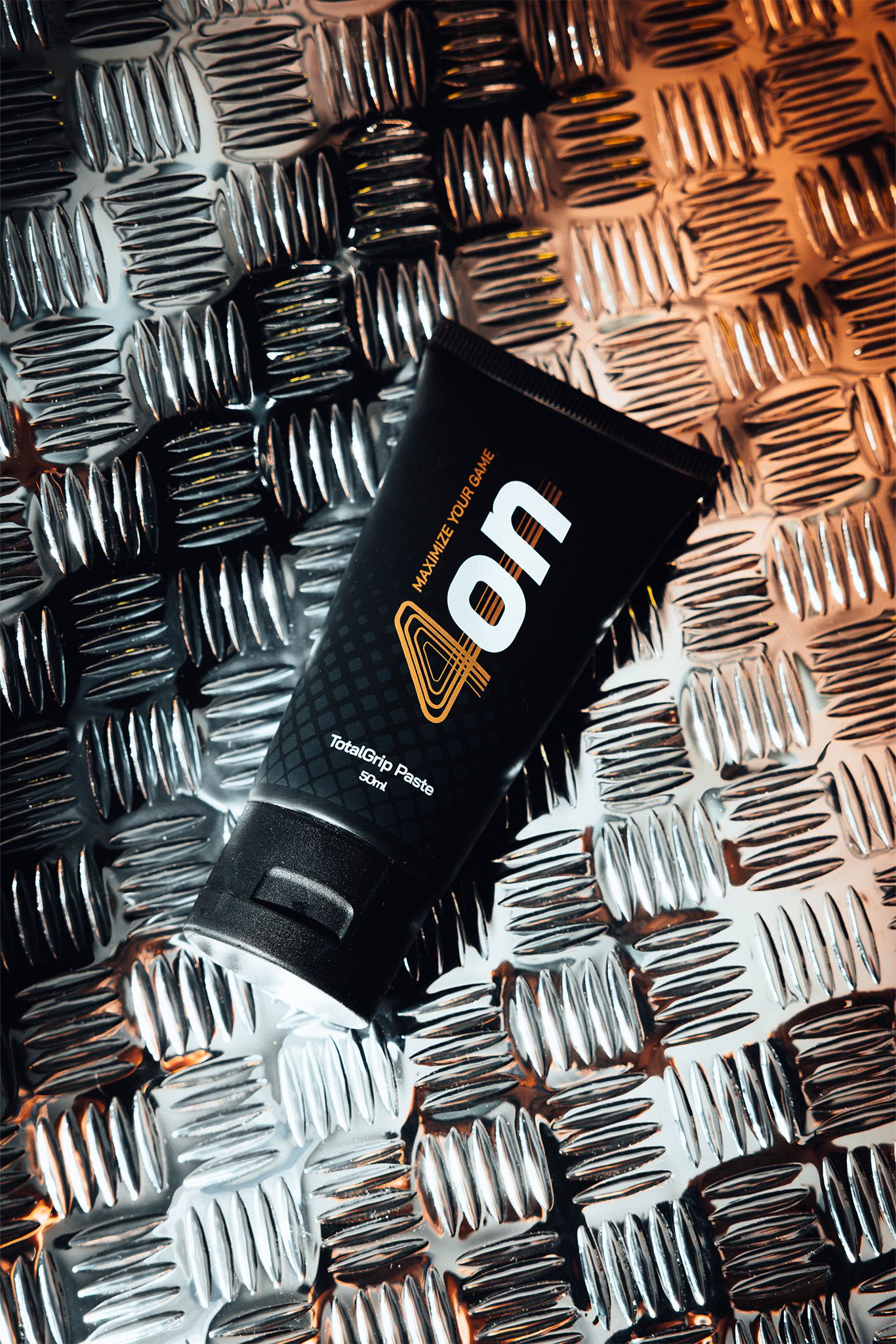 4on TotalGrip Paste tube with metallic background
