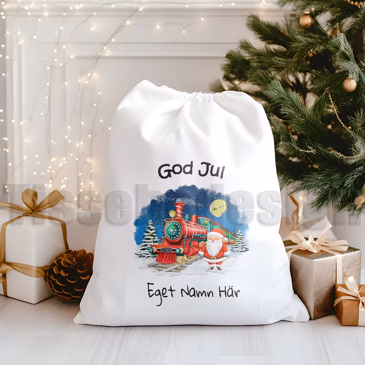 Julsäck med tryckt tomte och rött julklappståg samt God Jul-text