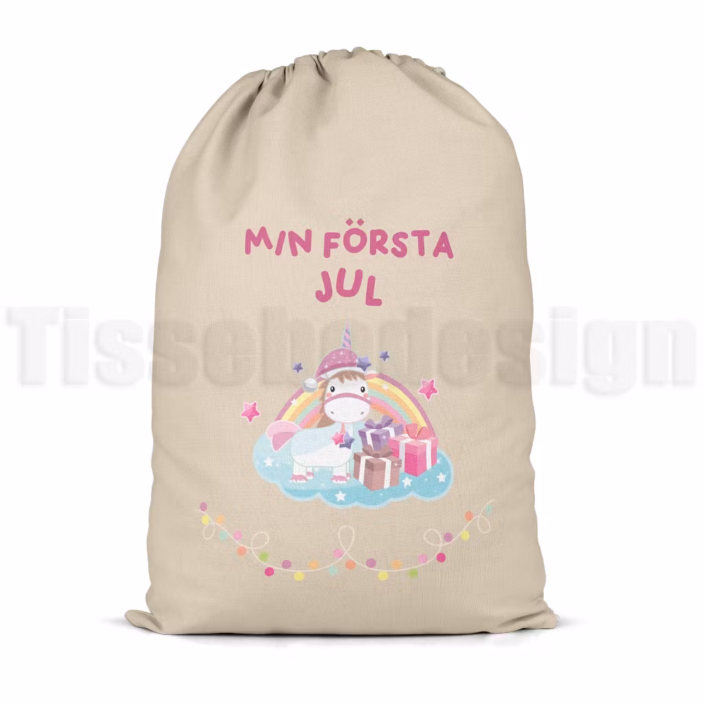 Julsäck i naturfärg med enhörning, regnbåge och paket – text Min Första Jul