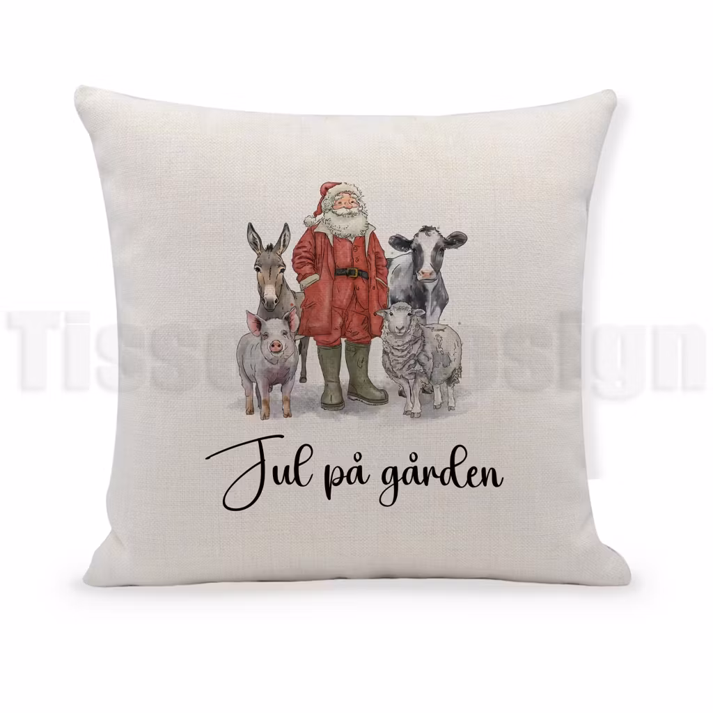 Kuddfodral i beige med julmotiv av tomte och gårdens djur samt texten Jul på gården.