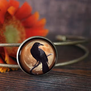 Manschettarmband – Kråkfågel, orange måne