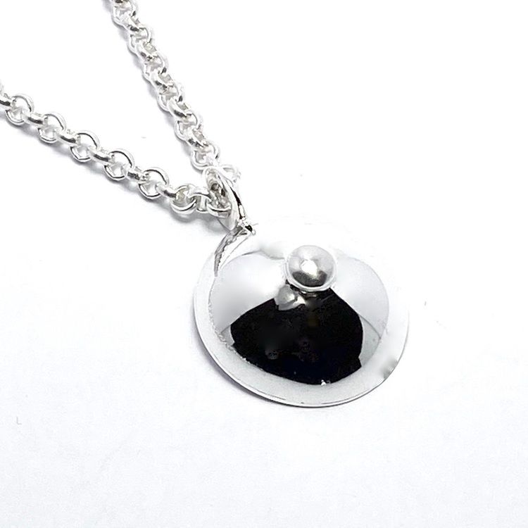Silverhängen i form av hängbröst. Silver pendants in three sizes