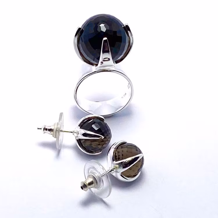 Stor silverring med en stor rund facettslipad rökkvarts och matchande örhängen. big silver ring with smokey quartz and matching earrings