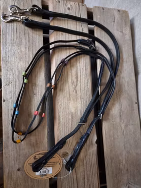 Hjälptyglel / Mollytygel stl ponny i svart läder och gummerad vävribb från Lippo. Nya