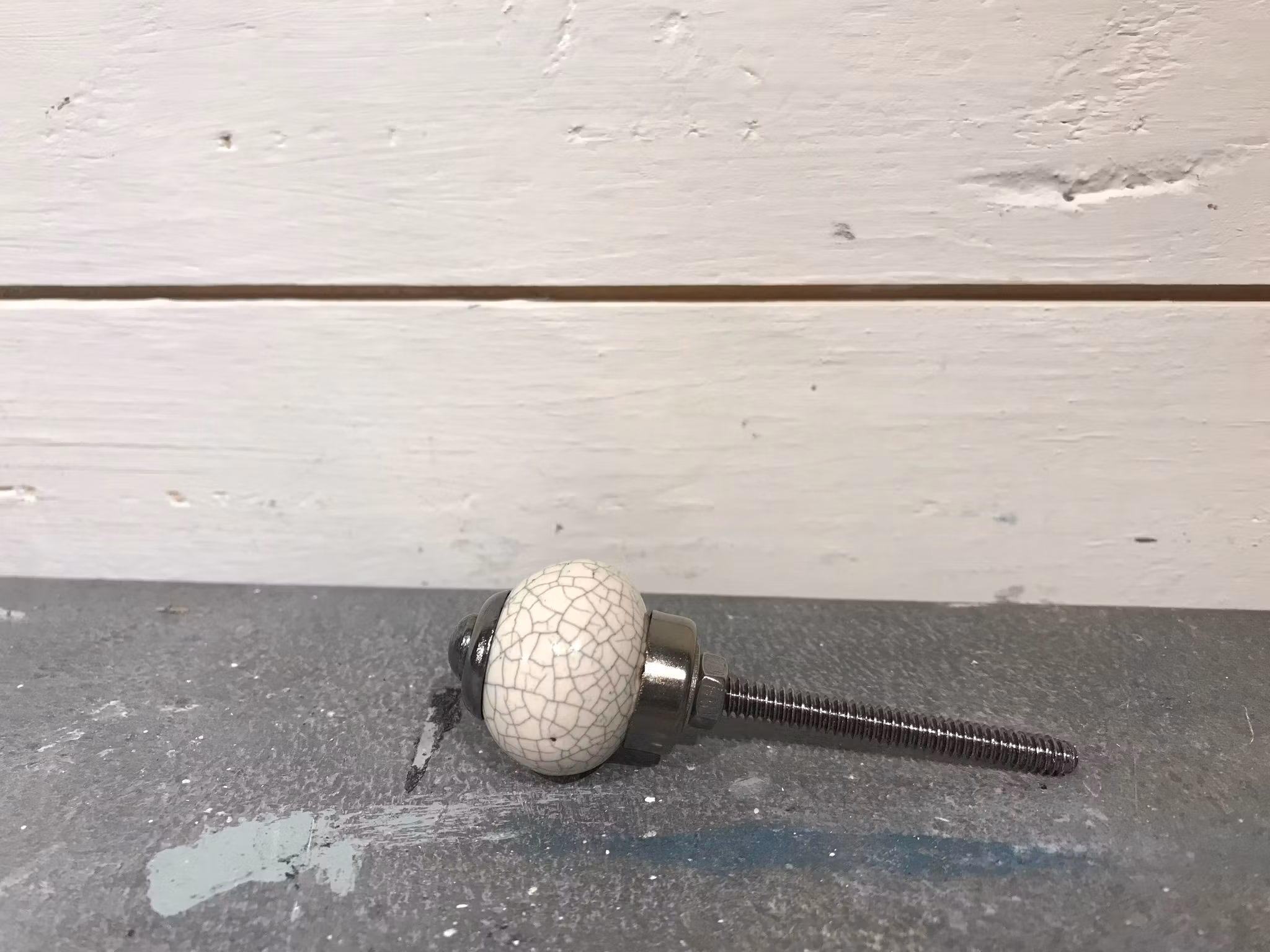Liten beige knopp med krackeleringar