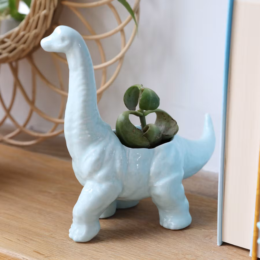 Bild på en kruka i keramik i form av en diplodocus dinousarie