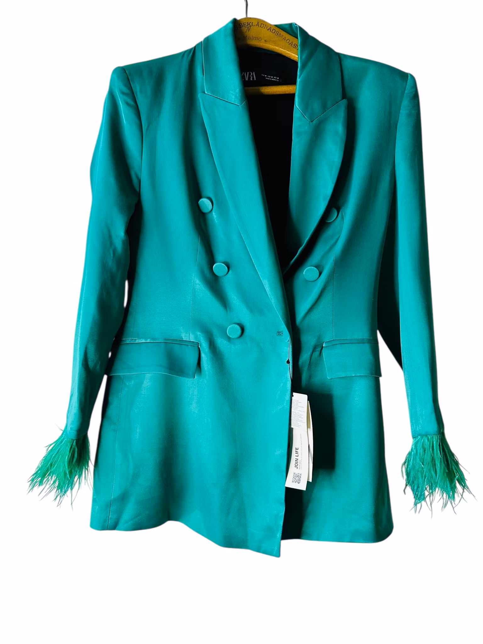 Grön kavaj med fjädrar