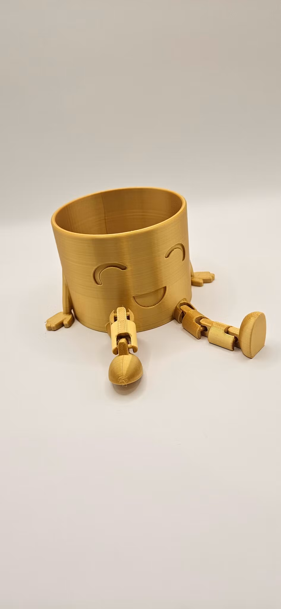 Kruka med ben och glad min – 7 cm