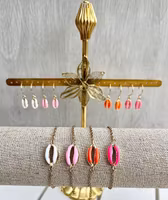 REA. Guldfärgat rostfritt stål connector snäcka cerise, 1 st