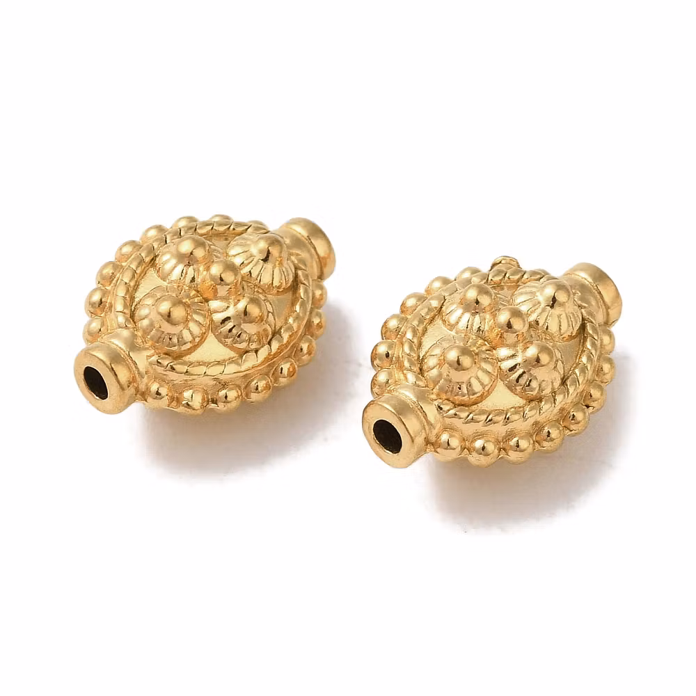 Kirurgiskt guldfärgat stål avlång mönstrad pärla med PVD plätering, 1 st