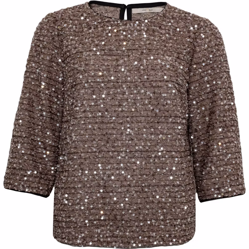 James top från Costamani, en sandfärgad top med 3/4-ärm och glittrande paljetter.