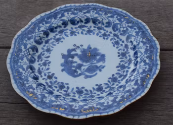 A antique chinese blue and white dish with molded rim period of Qianlong