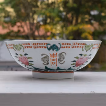 A large antique chinese bowl decorated with peach & bats Late Qing Dynasty