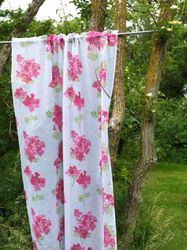 Pelargonia ett skirt vitt gardinset med rosa pelargonior och gröna blad och kanaler från Noble house.