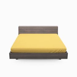 Solid color ett gult dra på lakan i bomull som även går att använda som sängtopp till madrasser, från Indusia design.