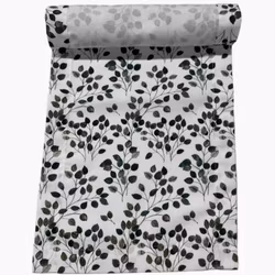 Noble house Bea en vit bordslöpare med med blad i grönt, grått och svart i mått 35 x 110 cm