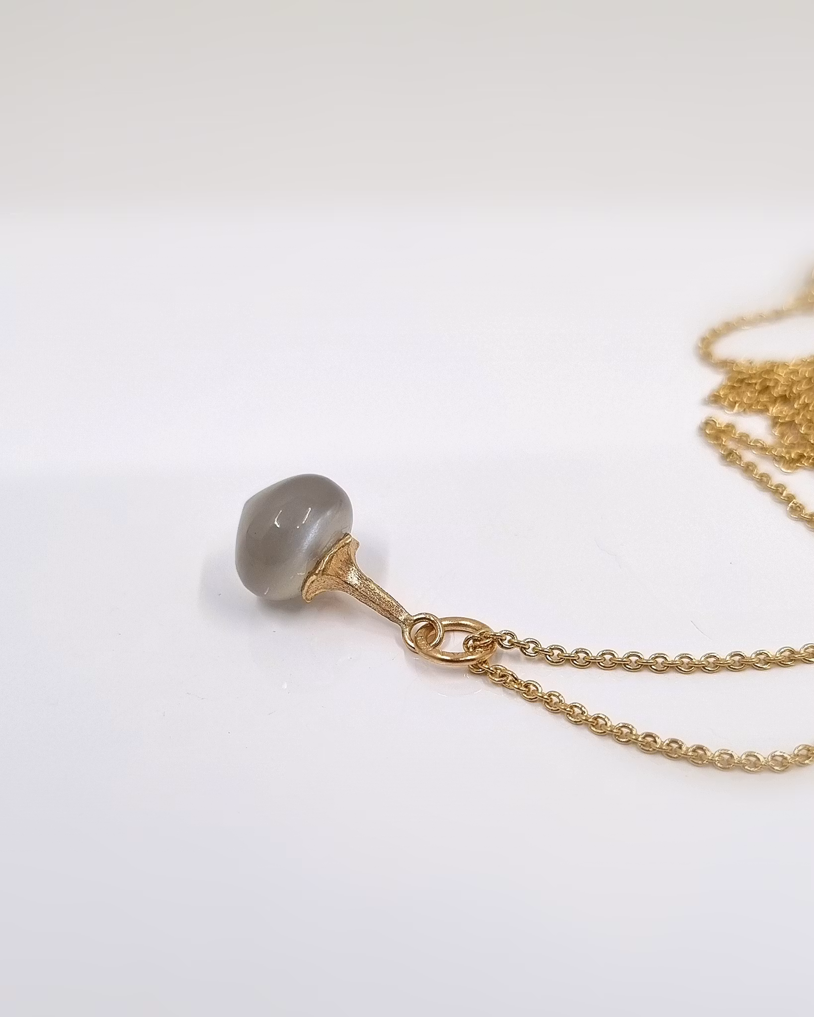 Änglatrumpet med varmgrå Månsten - hänge i 18K guld