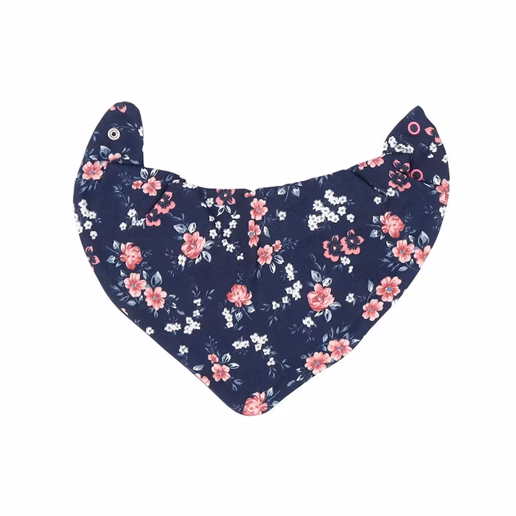 Marinblå dregglis med blommigt mönster från kollektionen Blommor. Dregglisen har tryckknappar i kragen.