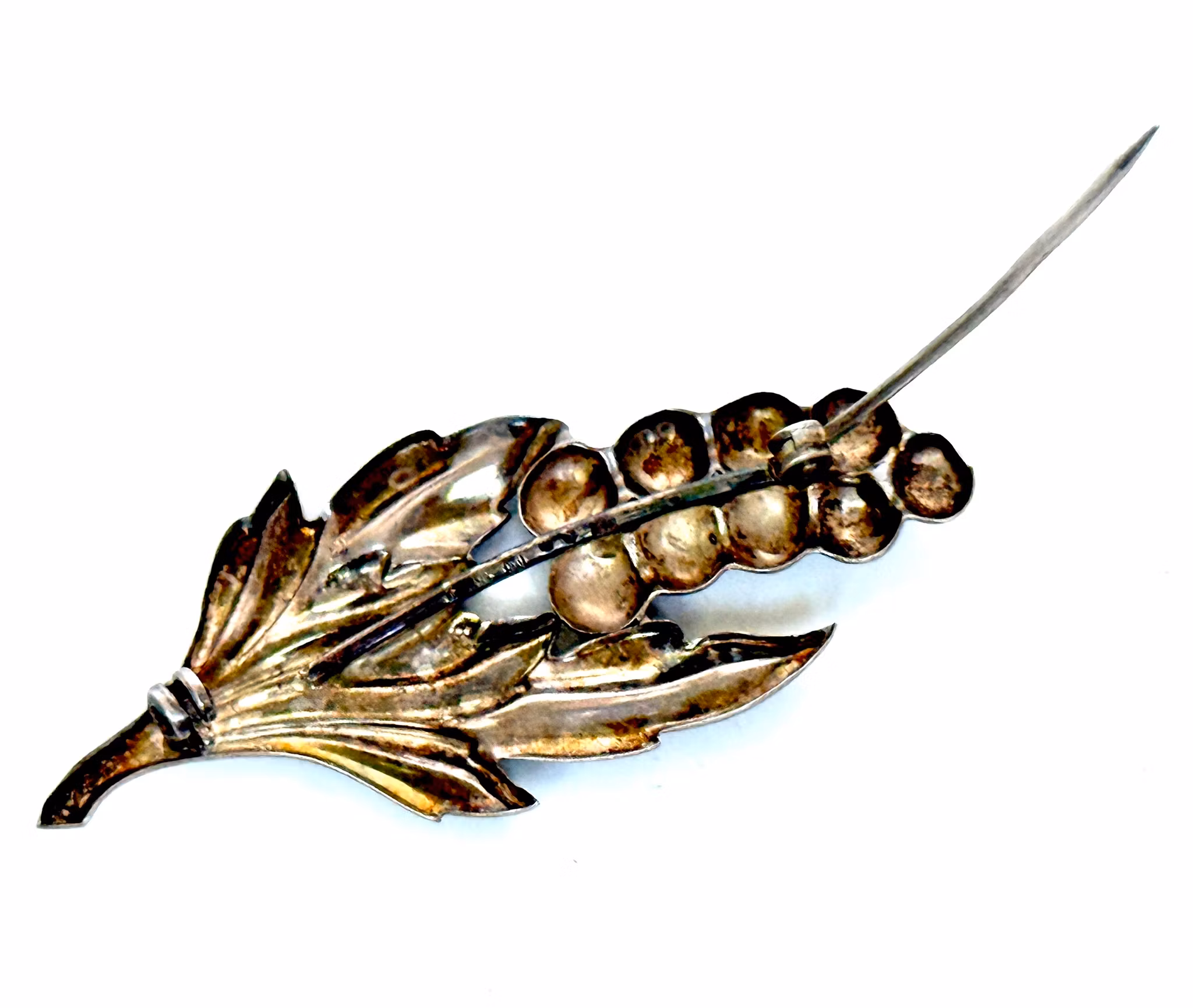 DG&Co hopeinen rintaneula orjanlaakerinlehdillä, 1951