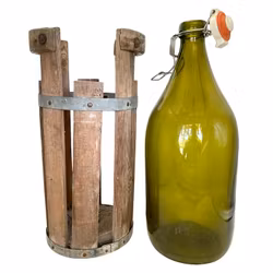 Botella grande de vidrio en soporte de madera.