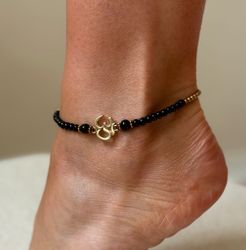 Fotlänk med Ohm i mässing och svart onyx